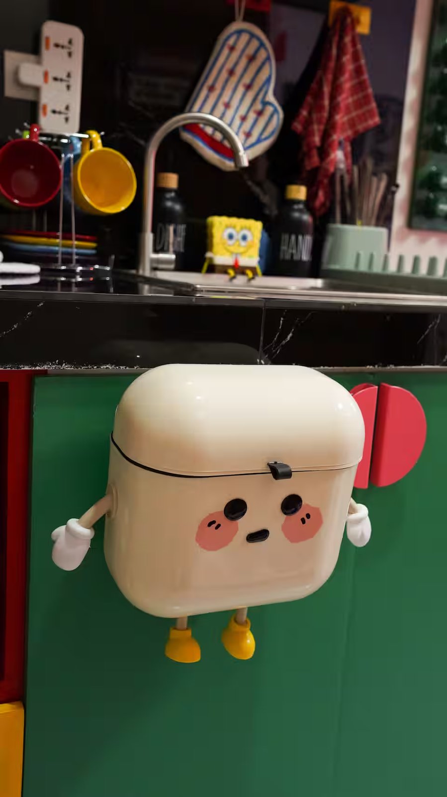 Marshmallow figure fridge magnet with Spongebob sponge holder by the kitchen sink